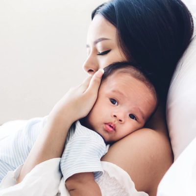 woman holding and hugging a calm baby