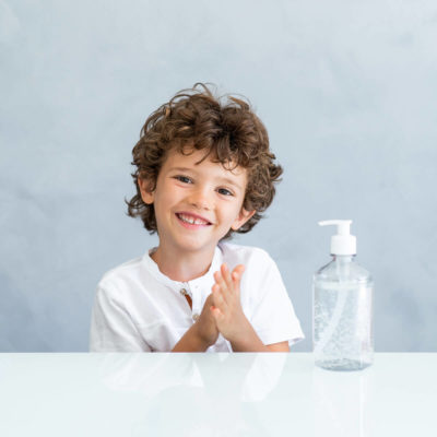 a young child with a bottle of hand sanitizer